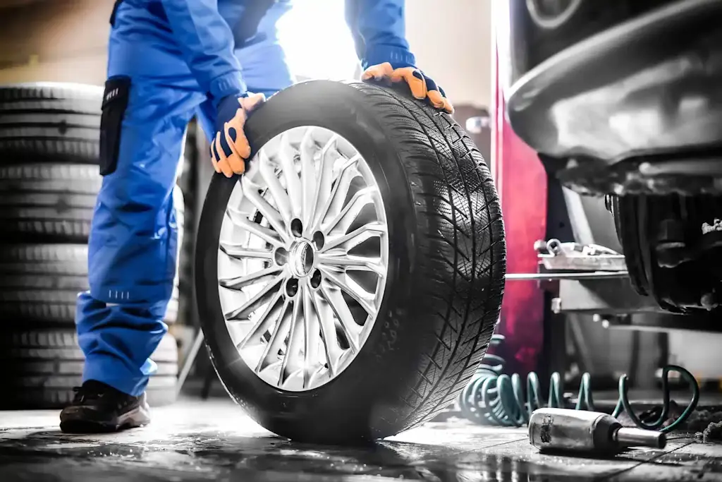 mobile tyre fitting technician rolling tyre